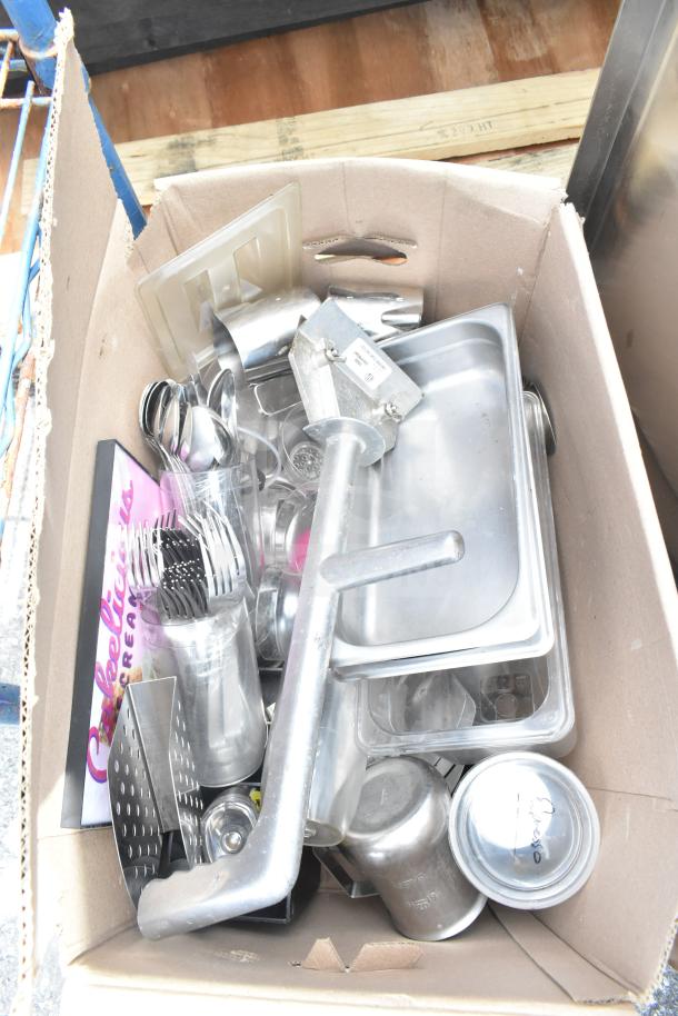 Boxed lot containing assorted kitchen items, including metal trays, utensils, and bins. Condition varies.