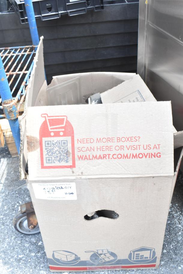 Cardboard box labeled with QR code, Walmart moving information, containing mixed items like bins and forks for auction.