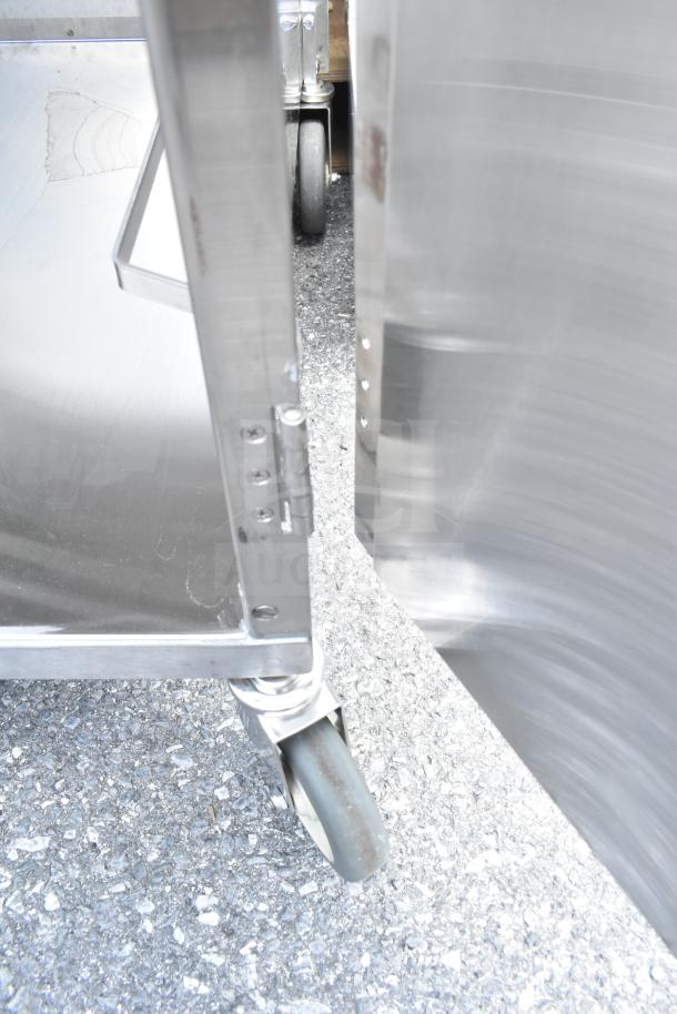 Lakeside Commercial Pan Transport Rack with enclosed design and commercial casters, shown on pavement.