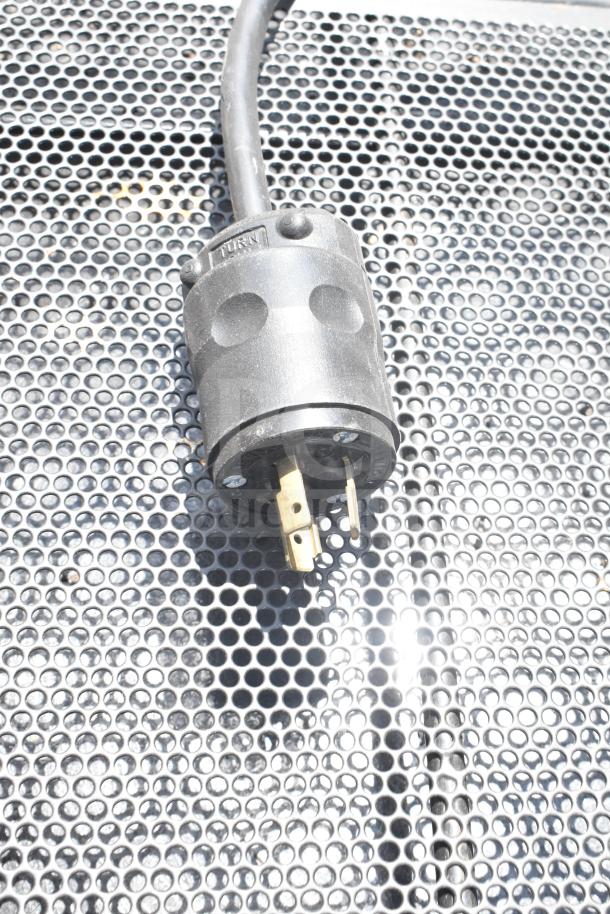 Killion Commercial Floor Style Open Grab N Go Merchandiser plug detail on perforated metal surface, 120/208-240V.