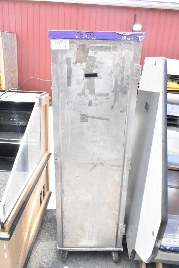 Commercial enclosed pan transport rack on casters, metal finish, used condition, visible label reads "135 Max OTY."