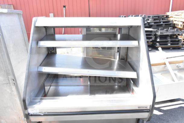 Commercial floor-style merchandiser display case by Custom's Deli Equipment, stainless steel, three shelves, good condition.