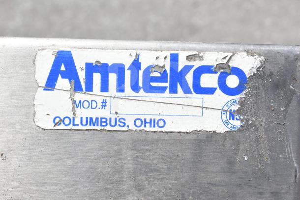 Amtekco sink label on a commercial 3 bay sink with dual drain boards, shows wear, located in Columbus, Ohio.