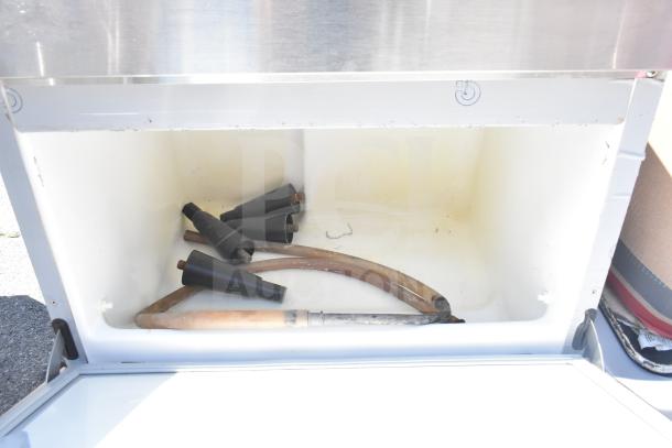 Hoshizaki commercial ice machine interior with hoses and nozzles visible, indicating need for assembly or maintenance.