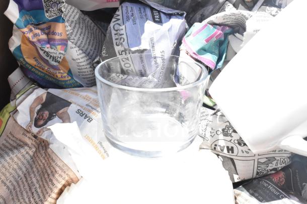 Two boxes containing assorted items: clear glass, white mug, wrapped in newspaper. Includes plates and more; bid multiplies by two.