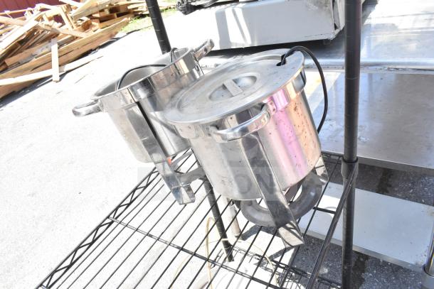Black 5-tier wire shelving unit, currently holding large stainless steel pots. Buyer must dismantle; freight charges apply.