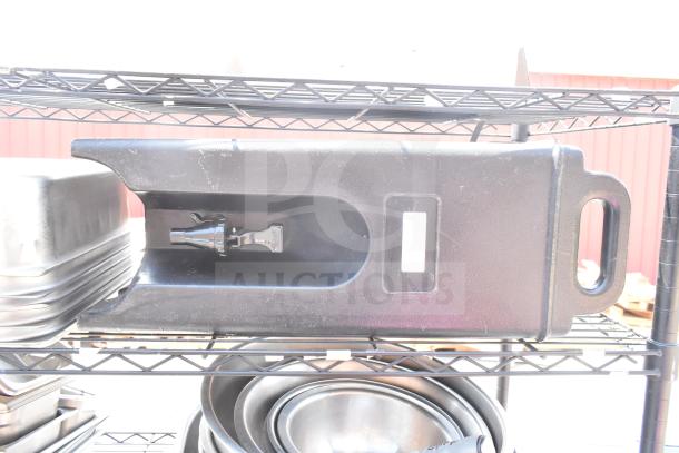 Black 5-tier wire shelving unit with contents, needs dismantling. Contains various kitchen items, visible wear on shelves.