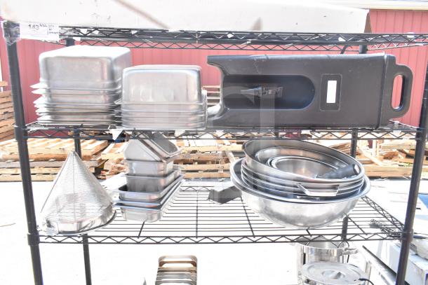 Black 5-tier wire shelving unit with various metal kitchenware. Buyer must dismantle. Consider freight charges.
