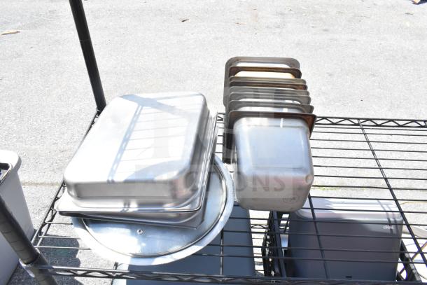 Black 5-tier wire shelving unit with assorted kitchenware; buyer must dismantle. Consider freight charges.
