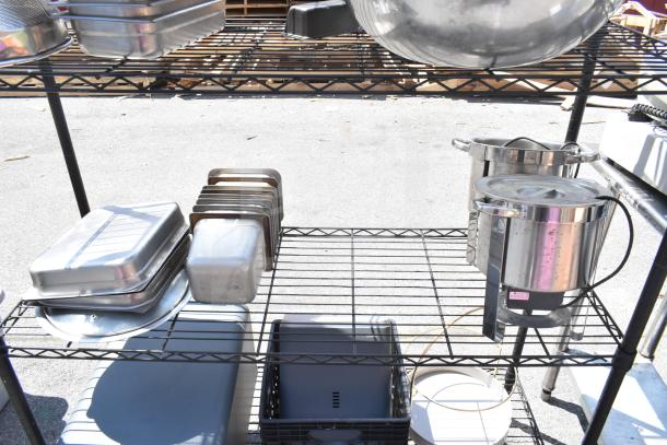 Black 5-tier wire shelving unit with various kitchenware. Shelves sturdy, good condition. Buyer dismantles.