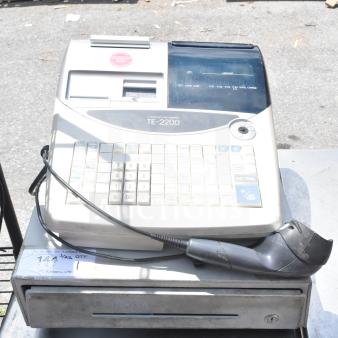 TE-2200 countertop electronic cash register with keypad and cash drawer. Includes attached barcode scanner. Visible wear.