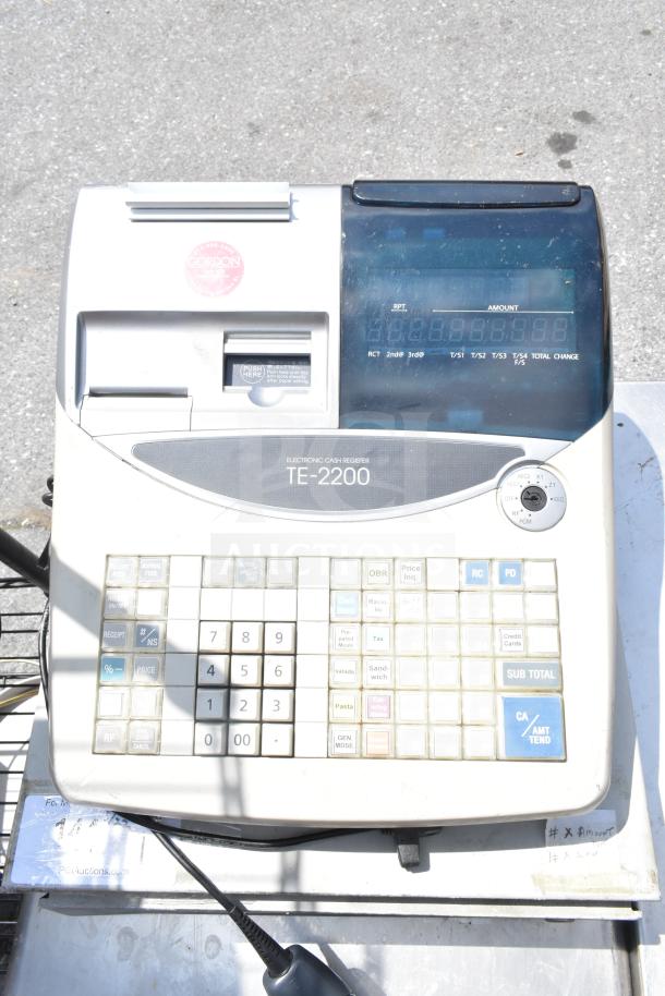 TE-2200 electronic cash register with large keypad and display, in used condition. Features include receipt and subtotal keys.