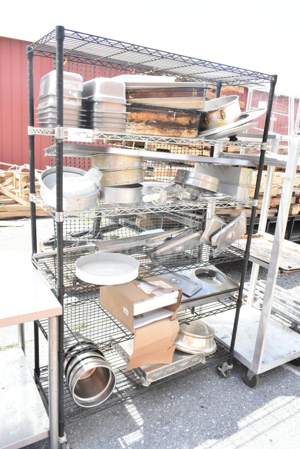 Chrome and black 6-tier wire shelving unit with contents, various kitchenware items visible, buyer must dismantle.