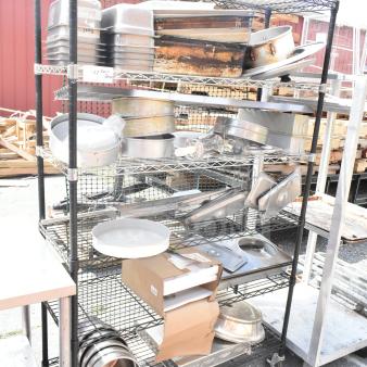 Chrome and black 6-tier wire shelving unit with contents, various kitchenware items visible, buyer must dismantle.
