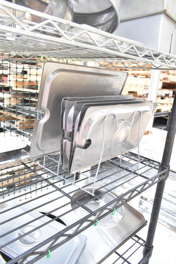 Chrome and black finish 6-tier wire shelving unit with stainless trays. Buyer must dismantle. Consider freight charges.