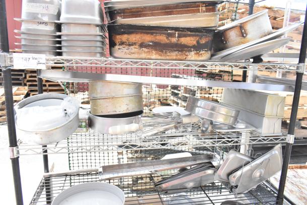 Chrome and black finish 6-tier wire shelving unit with assorted kitchenware. Buyer must dismantle for shipping.