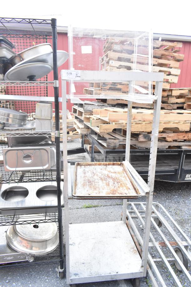 Commercial pan transport rack on heavy-duty casters, includes metal shelves; shows signs of use, ideal for kitchen storage.