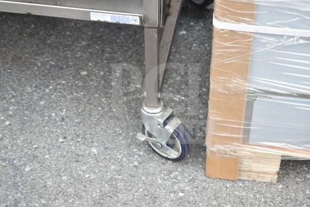 Commercial metal cart with under shelf, commercial casters, and National Cart Co. label visible. Good condition.