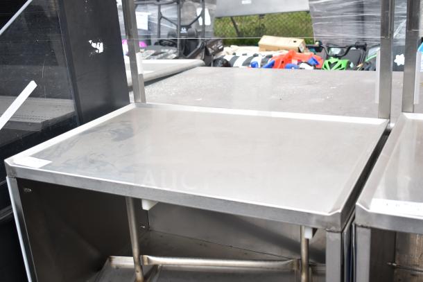 Sleek commercial cart with under shelf and durable stainless steel surface on commercial casters. Features sturdy frame.