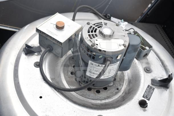 Greenheck 6-133-A-X commercial rooftop mushroom exhaust fan with visible control box, gray finish, in good condition.