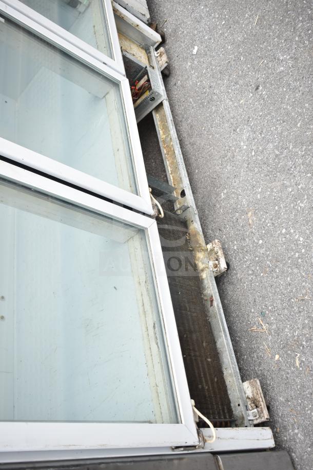 National ULG80BCP-6 commercial reach-in freezer, 3 glass doors, 115/208-230V, 1 phase, outdoor condition, visible wear.