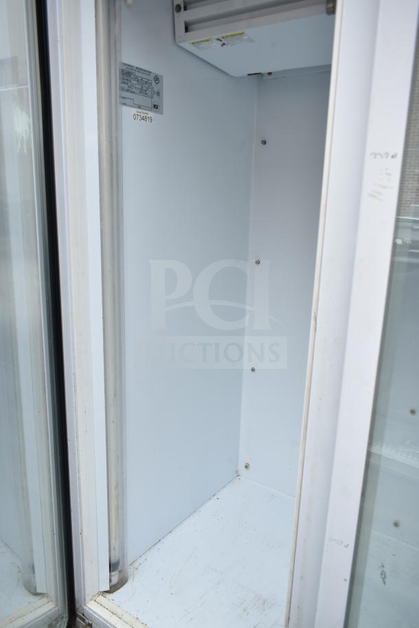 National ULG80BCP-6 commercial freezer interior, showing spacious, clean shelves. Model label and serial number visible.