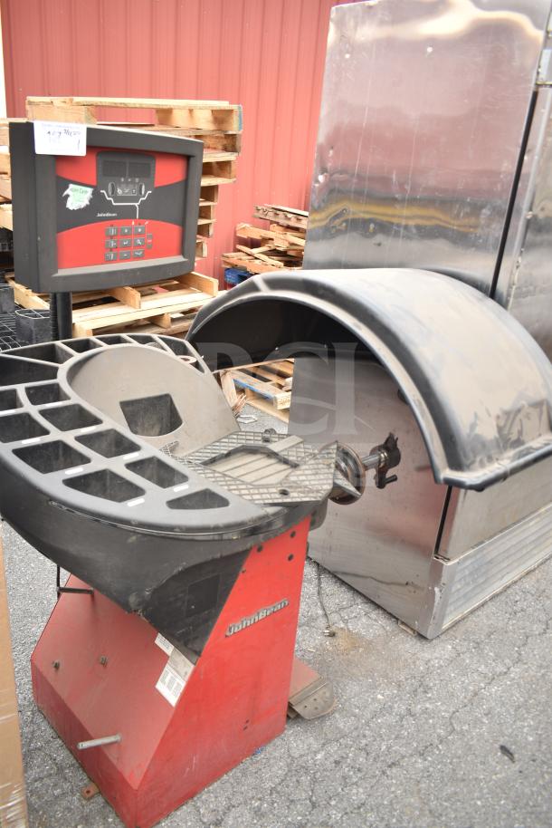JohnBean Commercial Balancer, red base with digital control panel, showing wear. Features protective wheel cover.