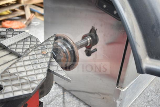 JohnBean Commercial Balancer, used, features metal spindle and rubberized components, showing minor wear.