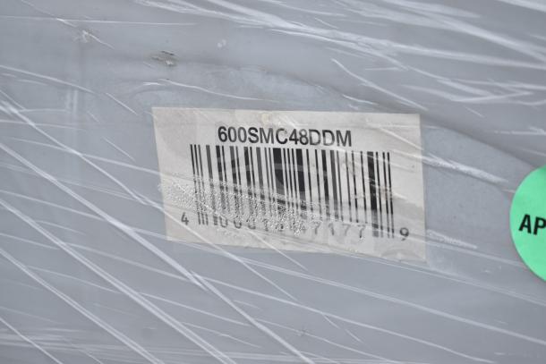 Barcode label on Regency 600SMC48DDM 48" stainless steel mop sink cabinet wrapped in protective material.