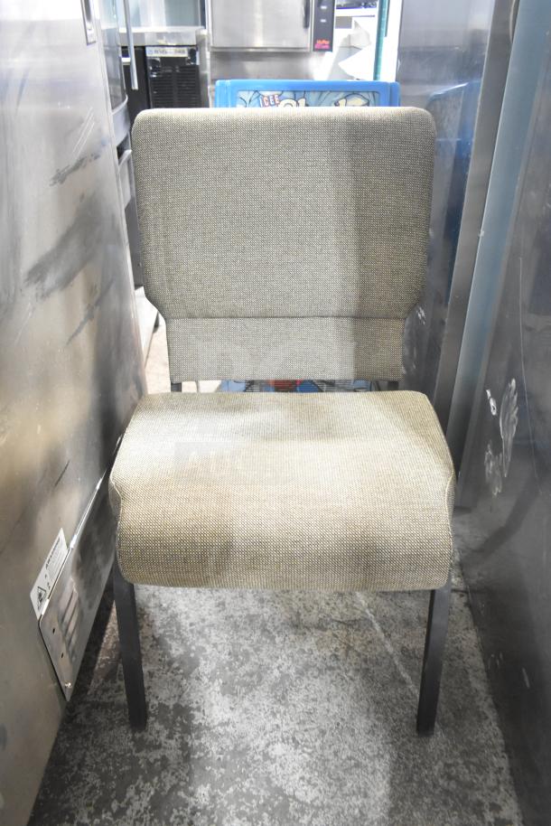 Bar stool with cushioned seat and backrest in neutral fabric, black metal legs, used condition. Part of a four-piece set.