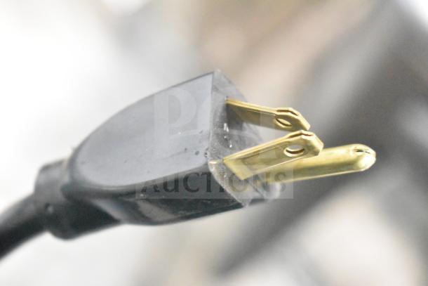 Close-up of a power plug from the FWE TS-1633-36P heated holding cabinet, designed for 120 volts, 1 phase.