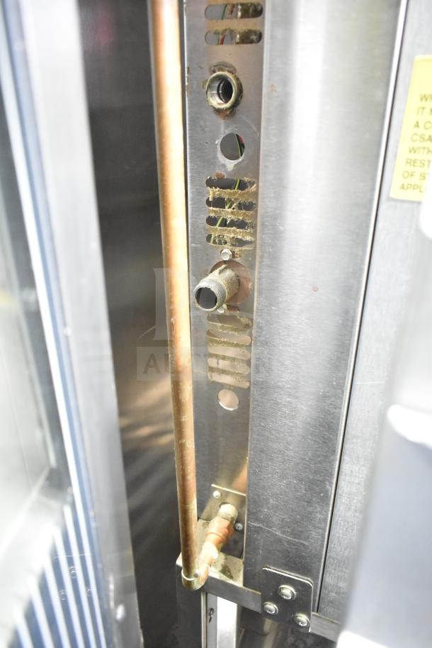 Baxter commercial gas-powered mini rotating rack oven, detailed view of internal components showing connections and structure.