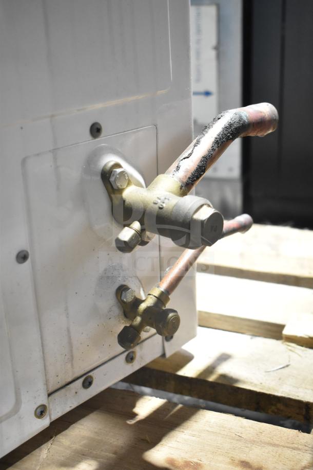 Copeland XFAM-010Z-TFC-081 condensing unit, 208-230V, 3-phase, shows valve connections, moderate wear evident.