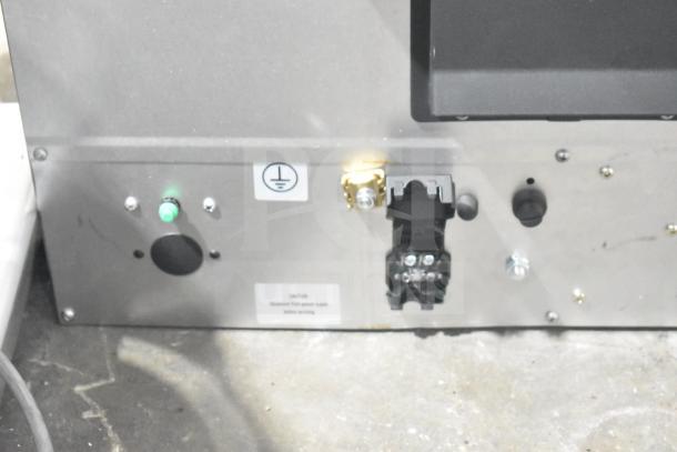 Cadco Unox XAFT133-US Arianna convection oven back panel showing power connections and caution label.