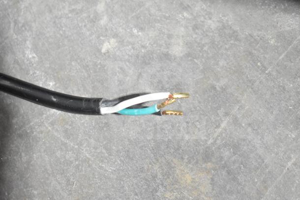 Damaged power cord with exposed wires from a Cadco Unox XAFT133-US Arianna convection oven, 208-240V, 1 phase.