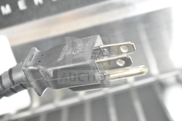 Power cord of 2022 Sharp R-21LVF Commercial Microwave Oven, 120 Volts, with visible prongs in excellent condition.
