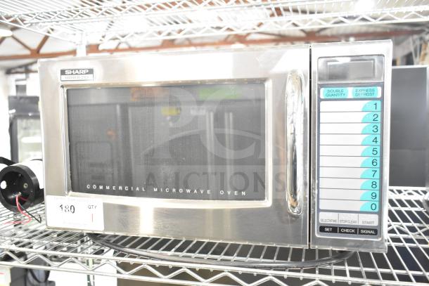 2022 Sharp R-21LVF Commercial Microwave Oven on metal shelf, keypad visible. 120V, 1 Phase, stainless steel exterior.