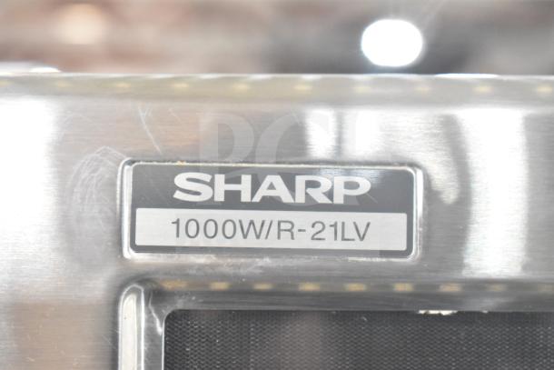Sharp R-21LVF commercial microwave oven, 1000W, with visible label showing model and wattage, stainless steel finish.