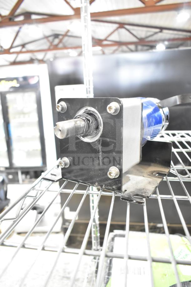 100ZYT51-GK60 motor, 130V, 1 phase, mounted on a metal frame. Appears in good condition with visible wiring.
