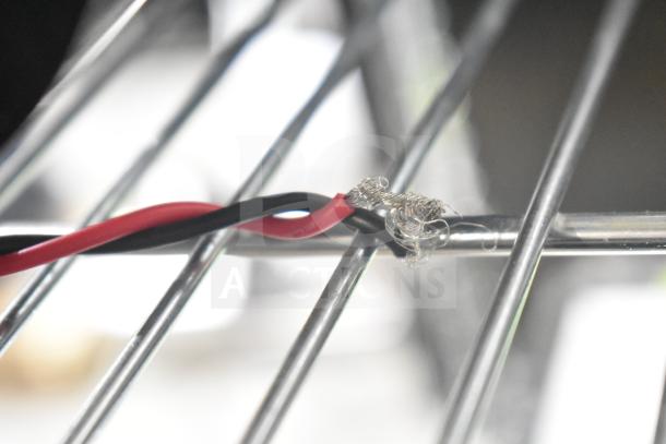100ZYT51-GK60 motor, 130 volts, 1 phase. Close-up of wires and metallic connections. Appears in good condition.
