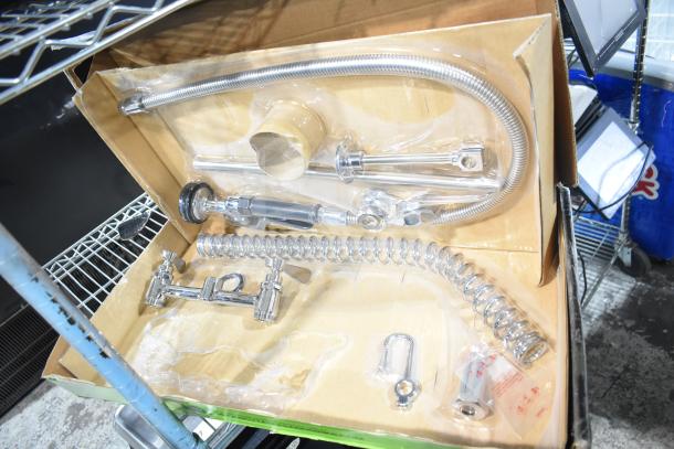Brand new Regency 600PRD8X pre-rinse faucet, deck 8", scratch and dent, with coiled hose and valves in original packaging.