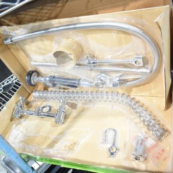 Brand new Regency 600PRD8X pre-rinse faucet, deck 8", scratch and dent, with coiled hose and valves in original packaging.