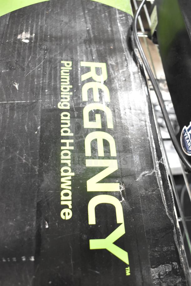 Image of a Regency 600PRD8X pre-rinse faucet box. The label reads "Plumbing and Hardware." The box shows signs of wear.