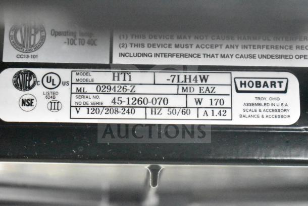 2023 Hobart HTi-7LH4W commercial scale label showing model, serial number, voltage, and assembly location.