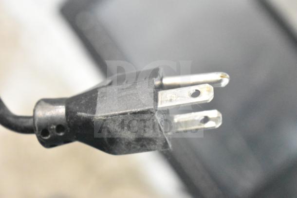 Black power plug for a 2016 Hobart HTi-7LH Commercial Food Scale, shown beside metal prongs. Screen damage is noted.