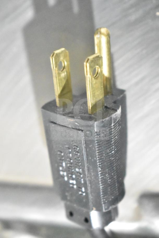 Close-up of a power plug for a Hobart HTi-7LH26 Commercial Scale, 120/208-240 Volts, showing prongs and texture.