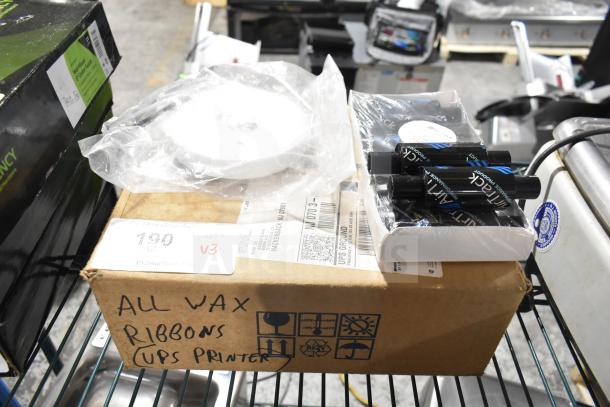 Box of wax ribbons labeled "UPS Printer," with packaged rolls visible, new condition. Includes three varied items.