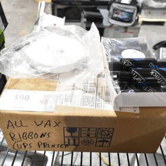 Box of wax ribbons labeled "UPS Printer," with packaged rolls visible, new condition. Includes three varied items.