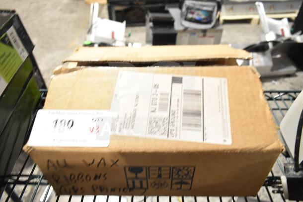 Cardboard box labeled "All Wax Ribbons" for UPS printer, includes three items; visible label with shipping details.