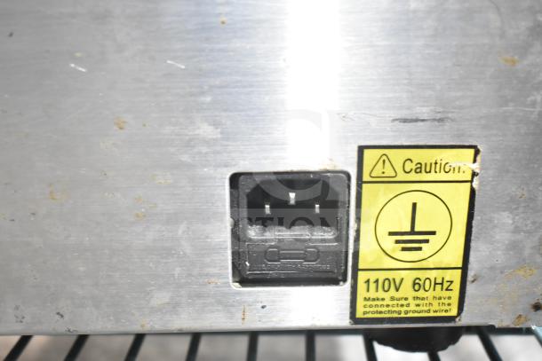 Alt text: VacMaster VP210 vacuum sealer back view, showing power socket and caution label for 110V 60Hz connection.